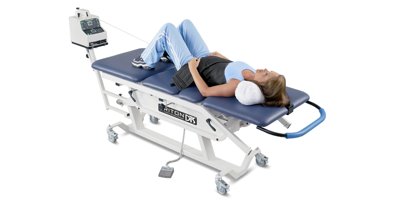 Patient on the Triton decompression therapy table used at Total Health Chiropractic